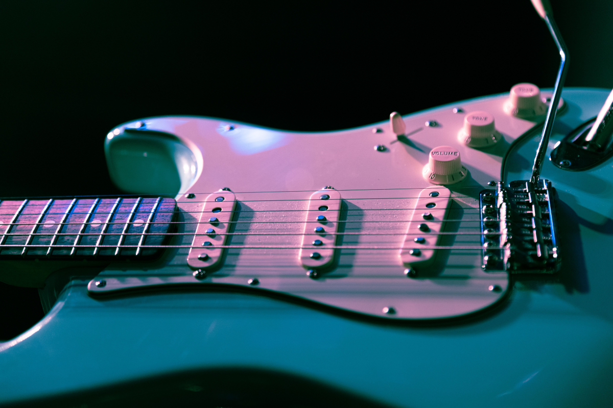 Strat-style electric guitar with a tremolo bridge and whammy bar